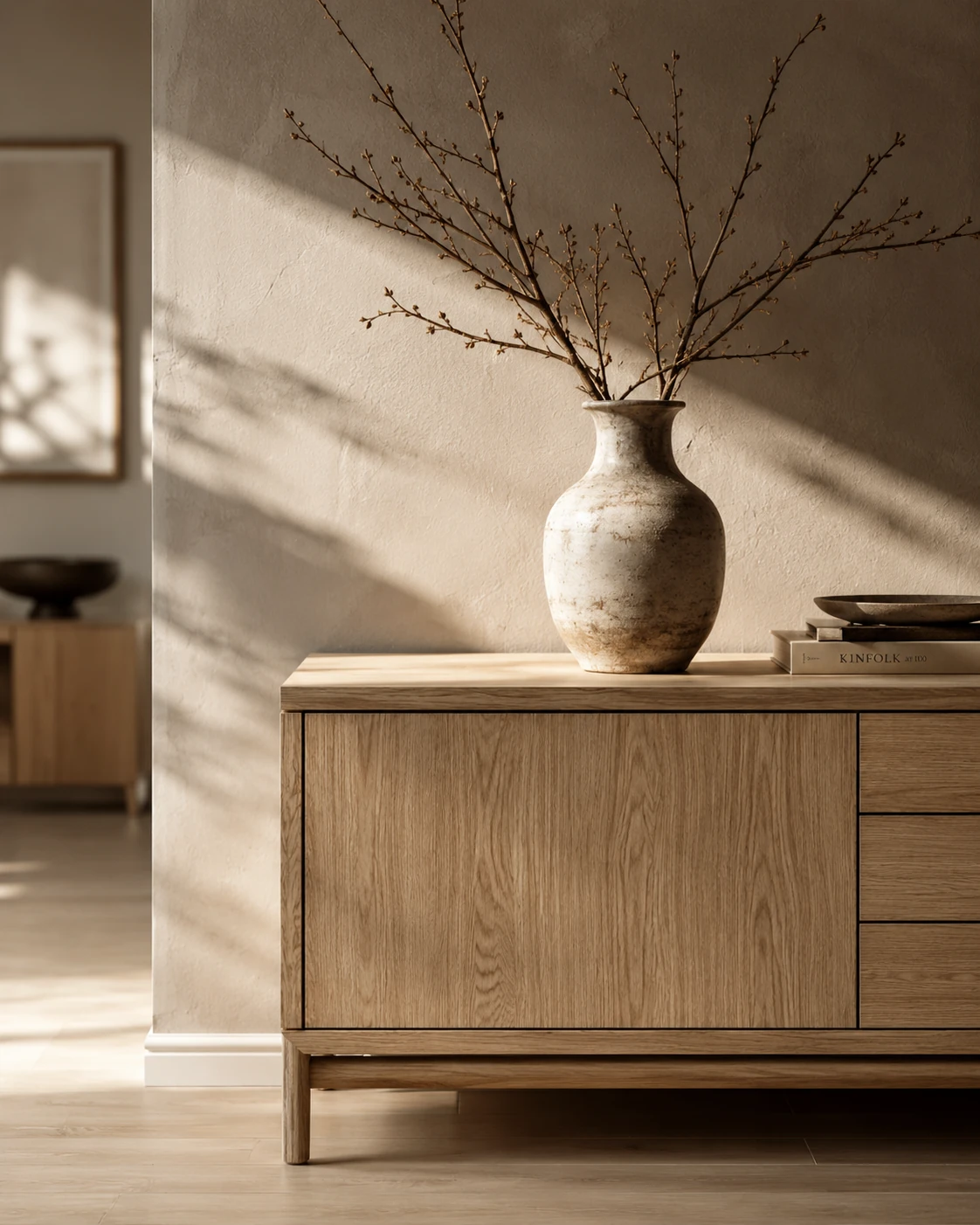 Warm minimalist interior detail with natural wood and ceramic vase